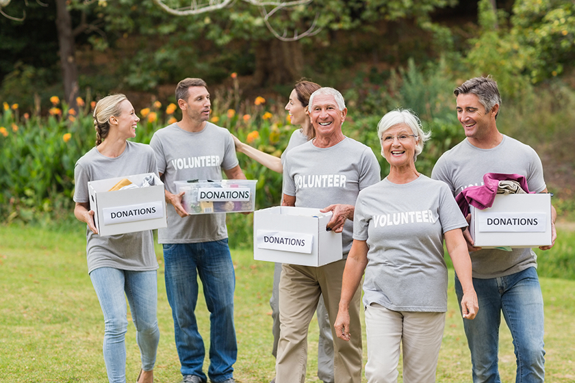 Happy volunteer family holding donations boxes