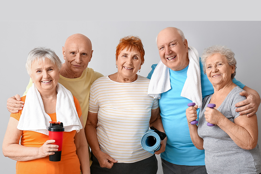 Portrait of sporty elderly people on light background 