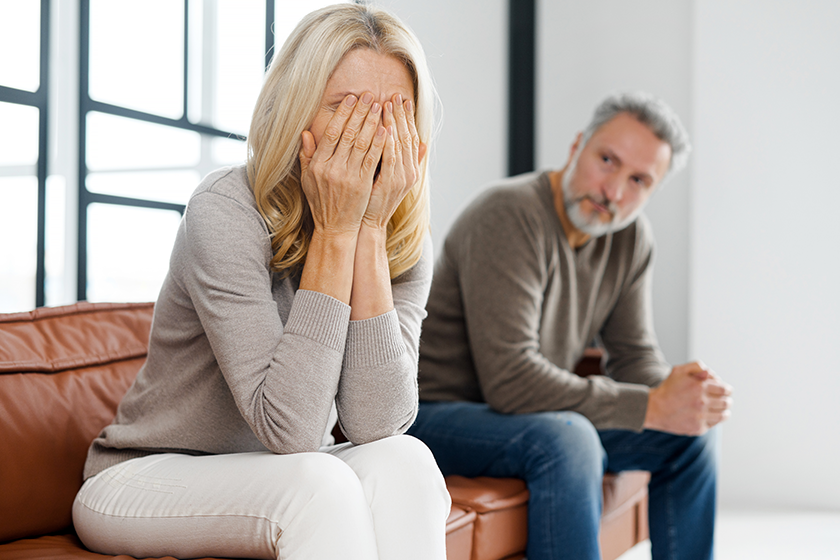 Upset middle-aged couple is arguing at home