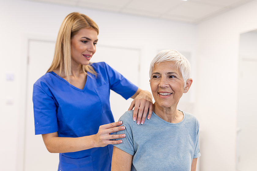 woman-doctor-osteopath-medical-uniform-fixing-senior-woman-patients-shoulder